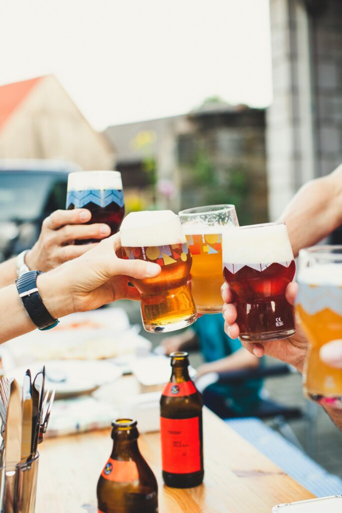 Parents cheering beer glasses at a kid-friendly brewery in Asheville