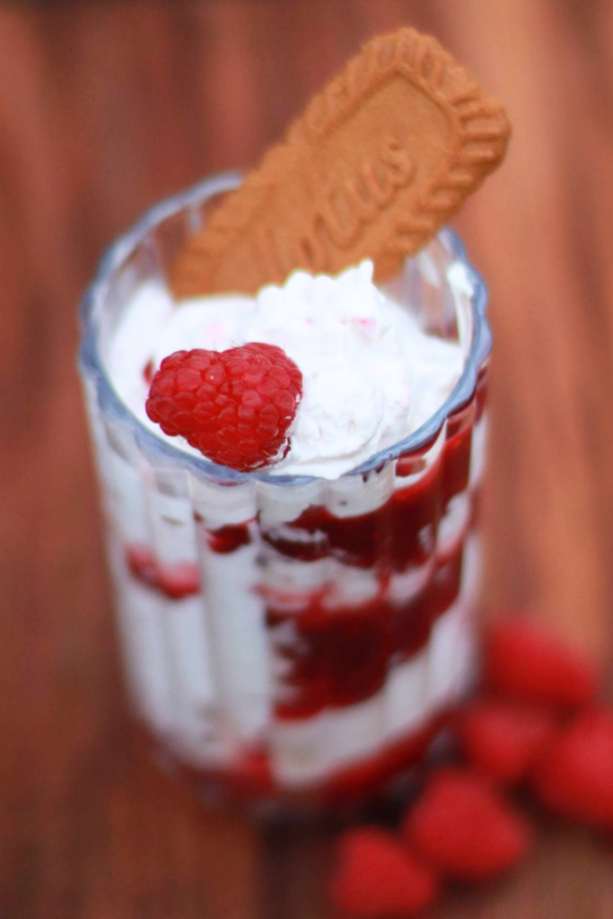 Whipped yogurt raspberry cookie parfait layered with fresh berries and cookie crumbs