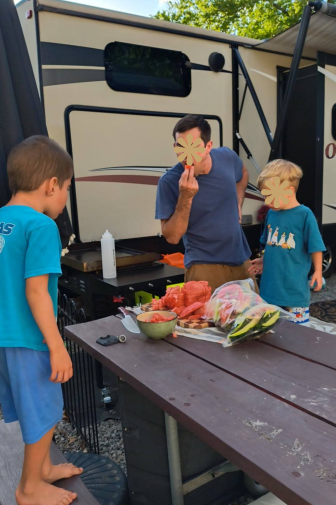 Full Time RV Living With Kids: 9 Essential Tips for a Successful Workamping Life 3 children sitting around eating watermelon full time rv living with kids