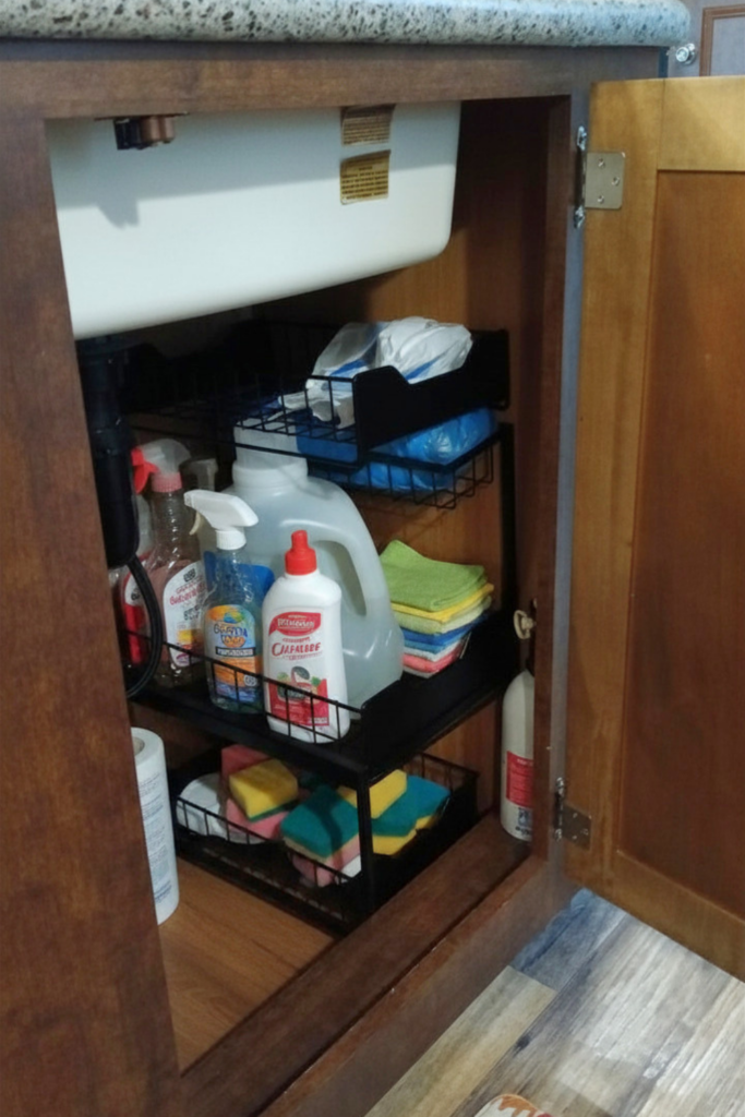 29 Genius RV Storage Ideas for Small Spaces with Kids 12 RV organization hacks with under-sink storage for cleaning supplies, sponges, and towels using space-saving organizers