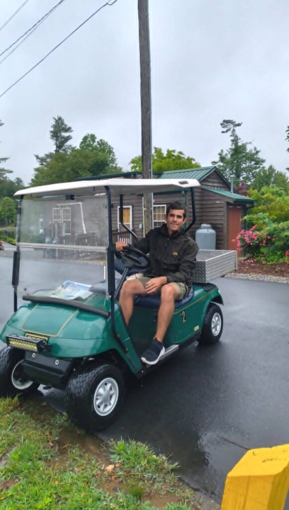 Full Time RV Living With Kids: 9 Essential Tips for a Successful Workamping Life 19 Workamping dad driving a golf cart during full time RV living with kids