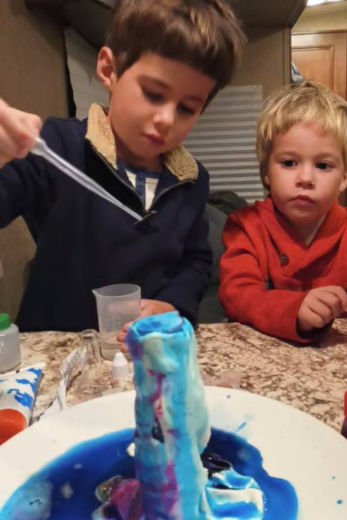 RV Activities for Kids: 50+ Amazing Ideas for Fun Family RV Living 6 Children performing a hands-on science experiment as educational RV activities for kids while traveling