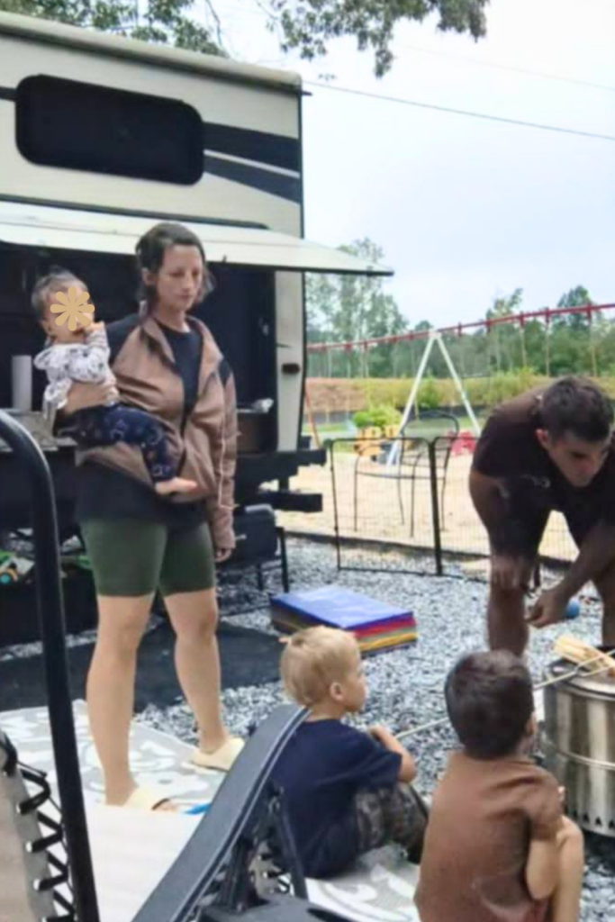RV Activities for Kids: 50+ Amazing Ideas for Fun Family RV Living 20 Family gathered around a campfire enjoying classic camping activities for kids at the campground