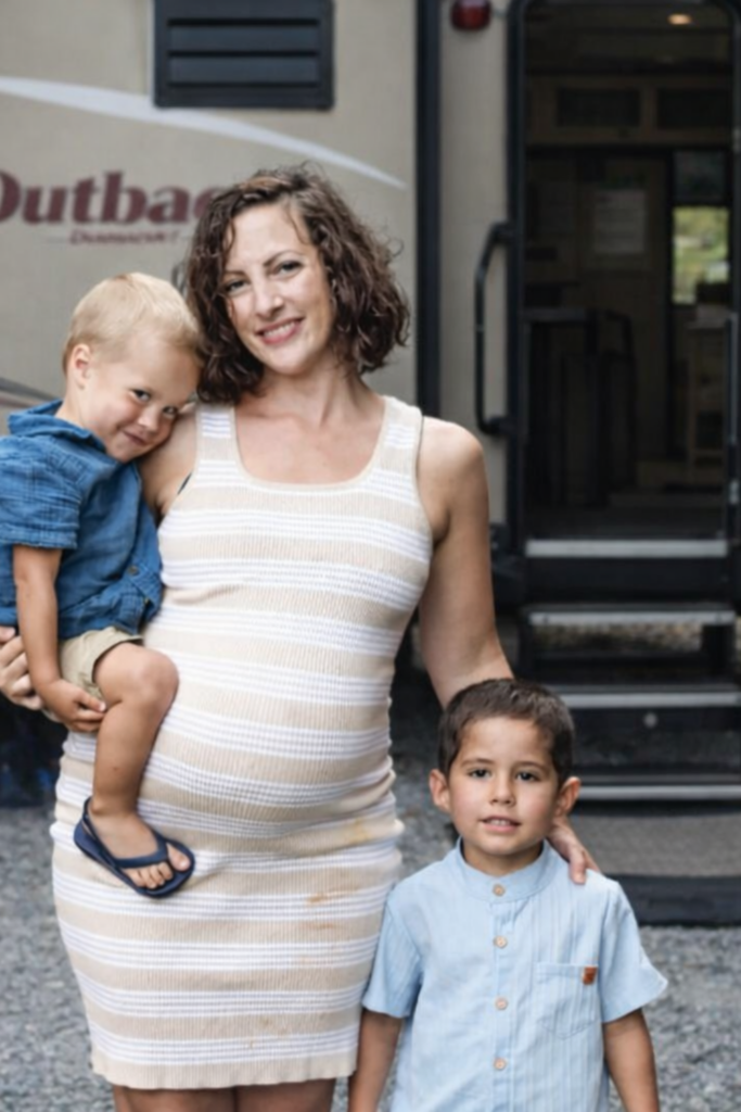 Family standing outside their RV during full-time RV living