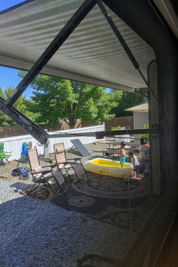 Kids swimming in a pool at their RV campsite outdoor setup
